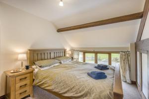a bedroom with a large bed with a wooden headboard at 4 Bed in Builth Wells oc-39473 in Builth Wells