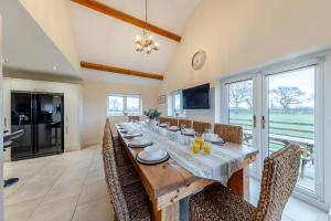 a dining room with a long table and chairs at 7 Bed in Caerwys oc-58357 in Caerwys
