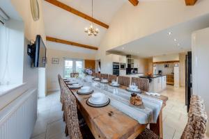 a large dining room with a long table and chairs at 7 Bed in Caerwys oc-58357 in Caerwys
