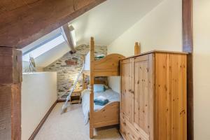 a bedroom with a bunk bed and a ladder at 4 Bed in Builth Wells oc-39461 in Builth Wells