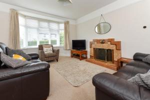 a living room with two couches and a fireplace at 4 Bed in Abersoch oc-dolwar in Abersoch
