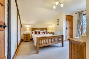 a bedroom with a bed and two tables and a window at 2 Bed in Caersws oc-waa345 in Trefeglwys