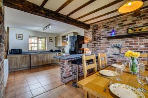 a kitchen with a table and a brick wall at 2 Bed in Welshpool oc-75703 in Meifod +18 photos