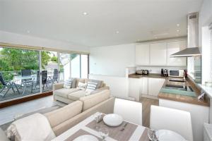 a kitchen and living room with a couch and a table at 2 Bed in Pwllheli oc-45caed in Abersoch