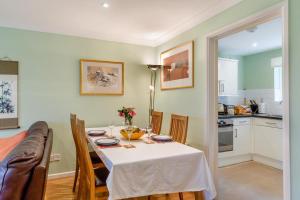 a dining room with a table and a kitchen at 2 Bed in Charmouth oc-wy395 in Charmouth