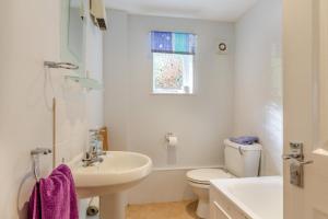 a white bathroom with a sink and a toilet at 2 Bed in Charmouth oc-wy395 in Charmouth +8 photos