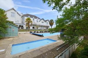 a large house with a swimming pool in a yard at 2 Bed in Charmouth oc-wy395 in Charmouth