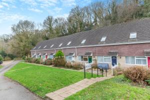 a brick house with a yard in front of it at 2 Bed in Charmouth oc-wy395 in Charmouth