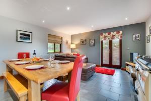 a dining room and living room with a wooden table at 3 Bed in Bala oc-bow162 in Bala