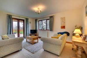 a living room with two chairs and a table at 3 Bed in Bala oc-bow162 in Bala
