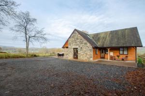 a stone house with a black roof on a gravel road at 3 Bed in Bala oc-bow162 in Bala