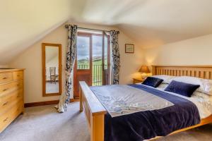 a bedroom with a bed and a large window at 4 Bed in Caersws oc-waa321 in Trefeglwys