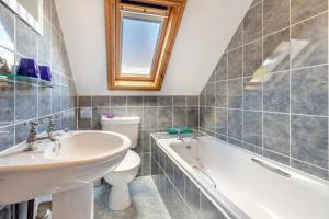a bathroom with a sink and a tub and a toilet at 4 Bed in Caersws oc-waa321 in Trefeglwys +10 photos