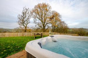 a jacuzzi tub in a backyard with a bench at 3 Bed in Bala oc-bow162 in Bala