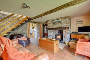 a living room with a couch and a fireplace at 2 Bed in Brecon oc-37318 in Pentre-bâch