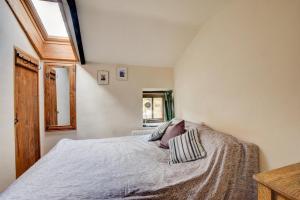a person laying on a bed in a bedroom at 2 Bed in Brecon oc-37318 in Pentre-bâch