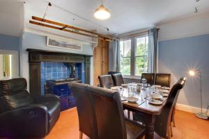 a dining room with a table and chairs and a fireplace at 6 Bed in Dolgellau oc-wah675 in Arthog