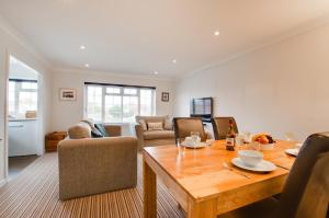 a dining room and living room with a wooden table at 2 Bed in Swanage oc-wy344 in Swanage