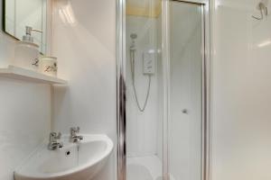 a white bathroom with a shower and a sink at 6 Bed in Dolgellau oc-wah675 in Arthog +20 photos