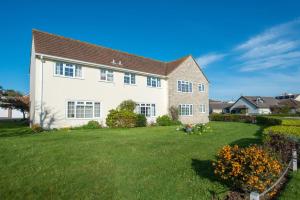 a large white house with a green yard at 2 Bed in Swanage oc-wy344 in Swanage