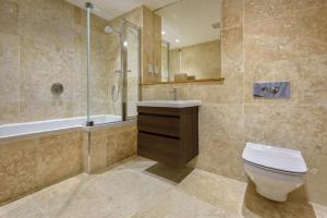 a bathroom with a toilet and a sink and a shower at 3 Bed in Abersoch oc-9penyb in Abersoch +27 photos
