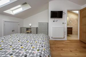 a bedroom with a bed and a television on the wall at 3 Bed in Abersoch oc-9penyb in Abersoch