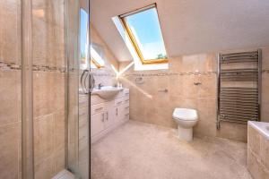 a bathroom with a toilet and a sink and a window at 5 Bed in Bryncroes oc-llecyn in Pwllheli +22 photos