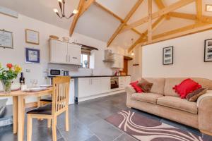 a living room with a couch and a table at 1 Bed in Gower oc-hh408 in Llanmadoc