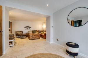 a living room with a couch and a mirror at 4 Bed in Gower oc-hh701 in Port-Eynon