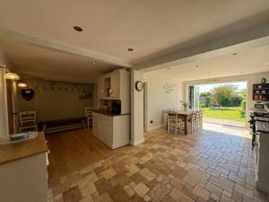 a kitchen and living room with a table and a kitchen and a dining room at 4 Bed in Gower oc-hh701 in Port-Eynon