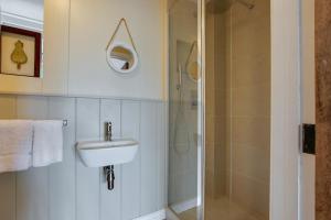 a bathroom with a sink and a shower at 4 Bed in Gower oc-hh701 in Port-Eynon +19 photos