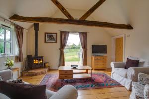 a living room with a couch and a table at 1 Bed in Frittenden oc-cb564 in Frittenden