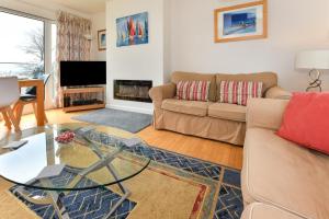 a living room with a couch and a glass table at 3 Bed in Pwllheli oc-16glyn in Llanbedrog