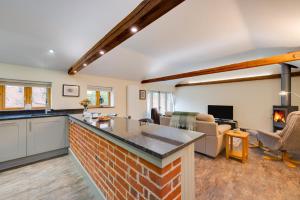 a kitchen and living room with a brick counter top at 1 Bed in Woodbridge oc-stabu in Ufford