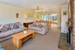 a living room with a couch and a table at 4 Bed in Pwllheli oc-morgra in Abersoch