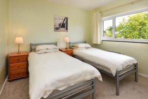 two beds in a room with a window at 4 Bed in Pwllheli oc-morgra in Abersoch