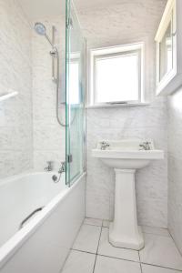 a white bathroom with a sink and a shower at 4 Bed in Pwllheli oc-morgra in Abersoch +22 photos