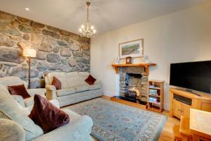 a living room with a stone wall at 2 Bed in Barmouth oc-wah698 in Talybont