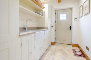 a kitchen with white cabinets and a sink and a door at 2 Bed in Upper Quinton oc-p33608 in Mickleton +28 photos