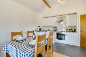 a kitchen and dining room with a table and chairs at 2 Bed in Gower oc-hh486 in Penclawdd