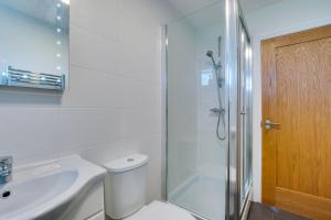 a bathroom with a shower and a toilet and a sink at 2 Bed in Gower oc-hh486 in Penclawdd +4 photos