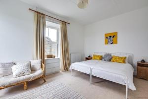 a bedroom with a white bed and a chair at 3 Bed in Hawes oc-ds959 in Hawes