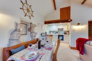 a dining room with a table and a kitchen at 3 Bed in Benllech oc-24195 in Benllech