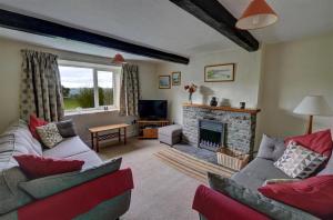 a living room with a couch and a fireplace at 4 Bed in Presteigne oc-wak235 in Norton