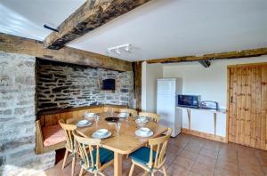 a dining room with a wooden table and chairs at 4 Bed in Presteigne oc-wak235 in Norton