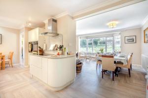 a kitchen and dining room with a table and chairs at 4 Bed in Godalming oc-b30296 in Hook