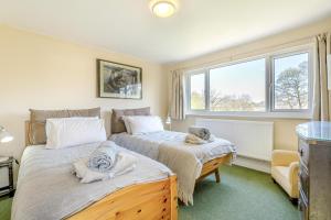 a bedroom with two beds with towels on them at 4 Bed in Godalming oc-b30296 in Hook