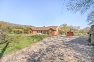 a house on a hill with a dirt road at 4 Bed in Godalming oc-b30296 in Hook