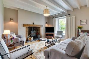 a living room with a couch and a fireplace at 5 Bed in Gower oc-hh101 in Port-Eynon