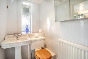 a white bathroom with a toilet and a sink at 1 Bed in Mumbles oc-hh631 in Oystermouth +12 photos